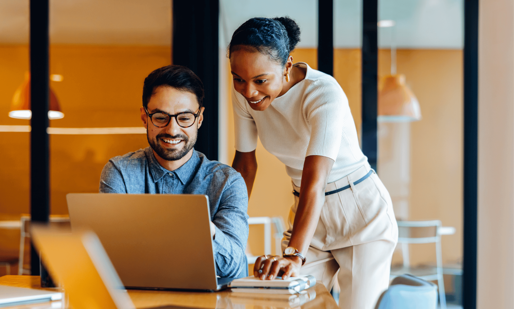 Two people looking at a laptop.