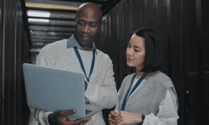 Two people looking at a laptop
