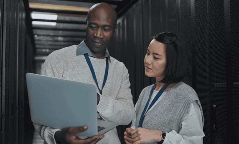Two people looking at a laptop
