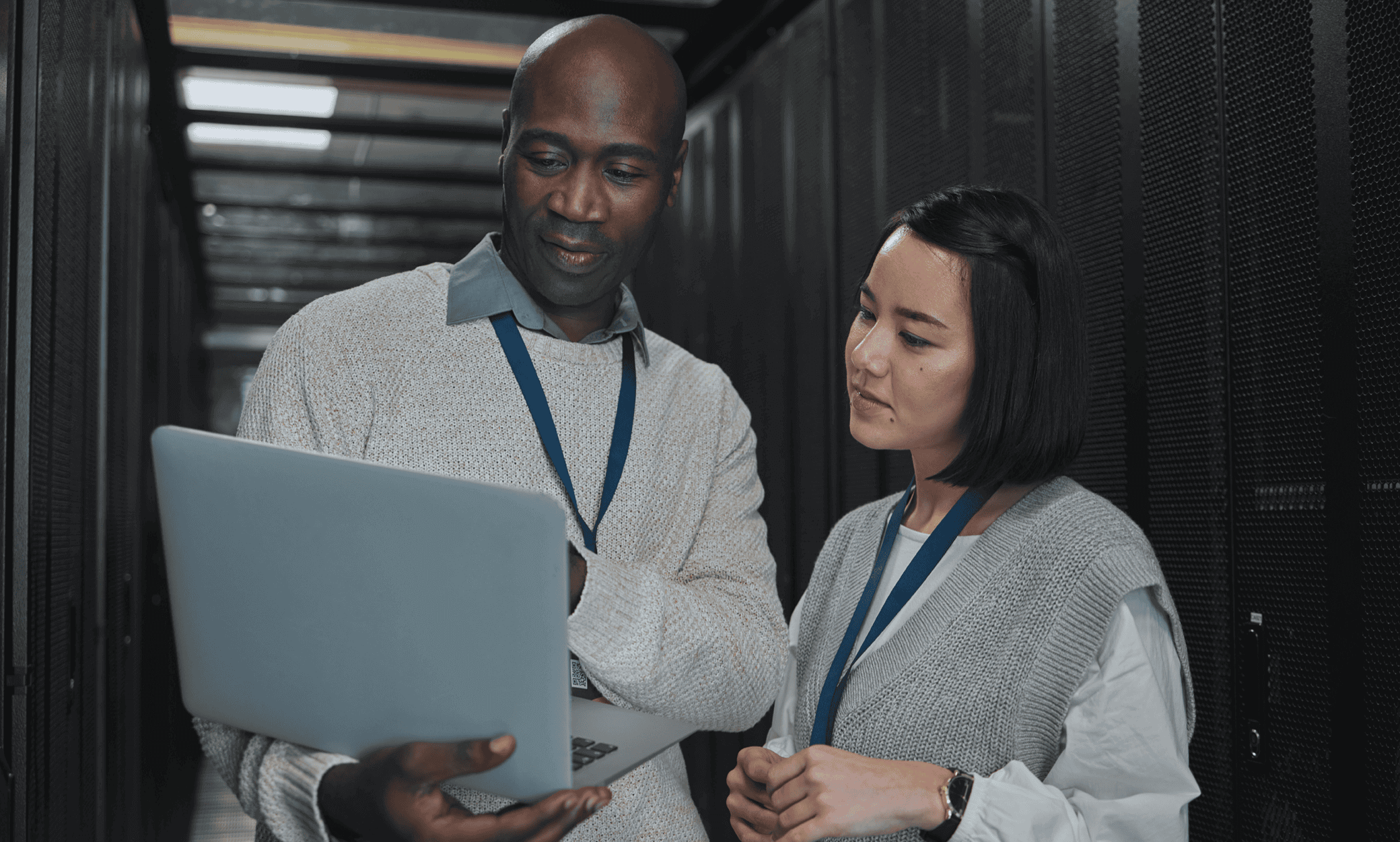 Two people looking at a laptop