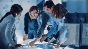 People standing around a table looking at research