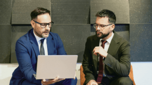 Two people looking at a laptop.