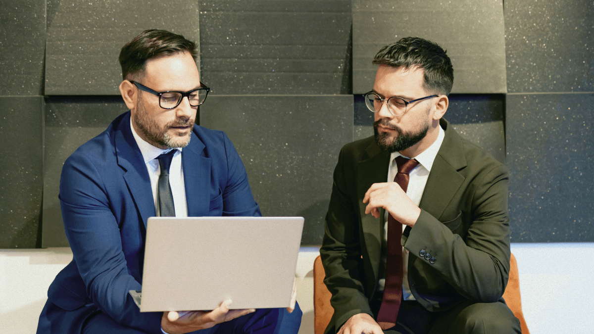 Two people looking at a laptop.