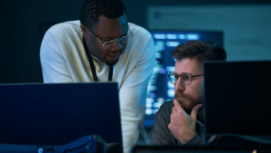 Two people looking at a computer