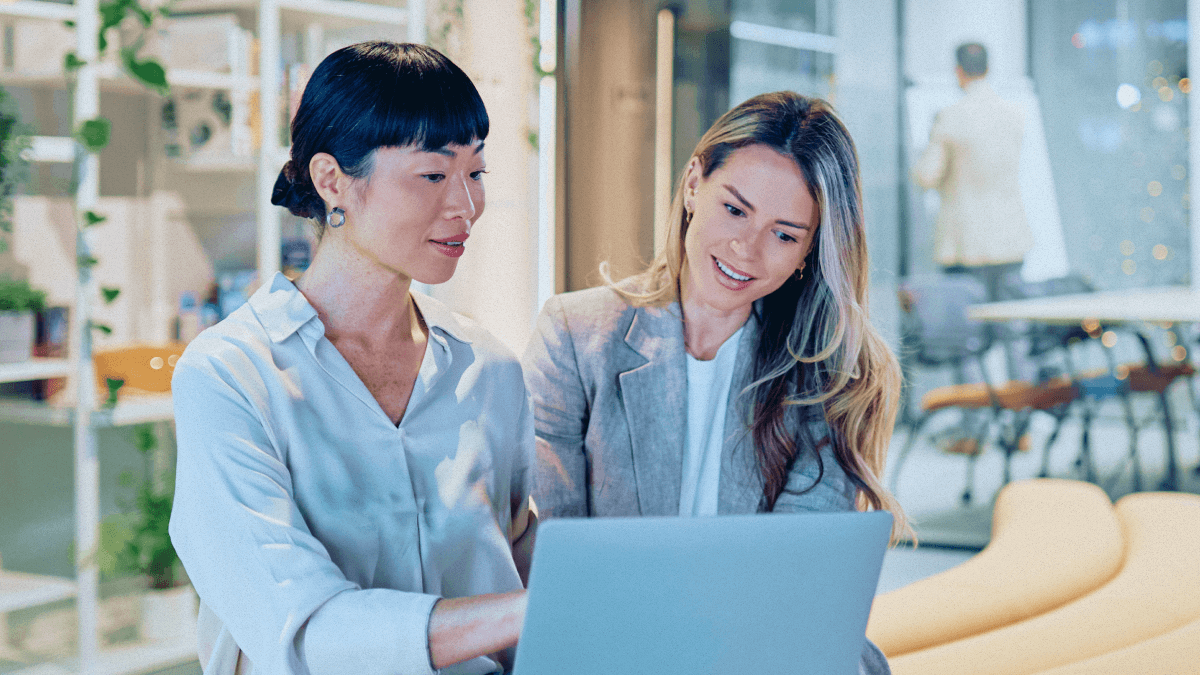 Two people looking at a laptop.