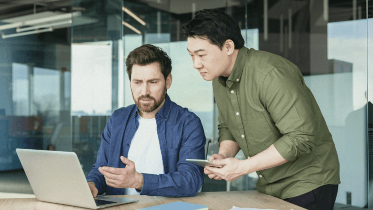 Two people looking at a laptop