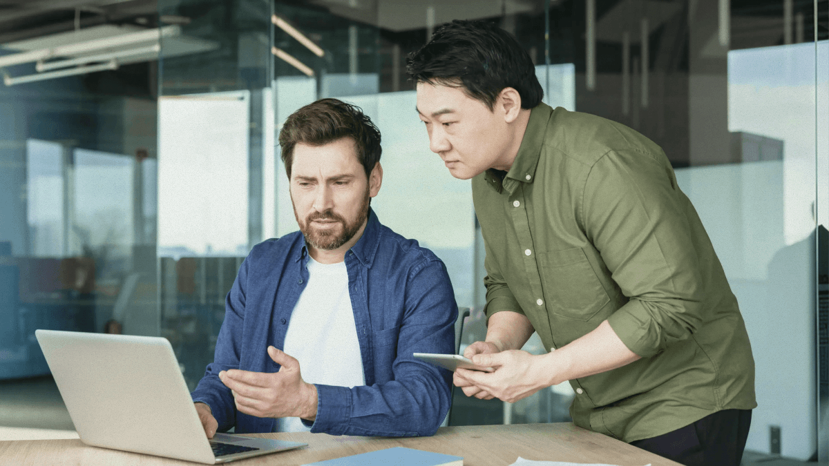 Two people looking at a laptop