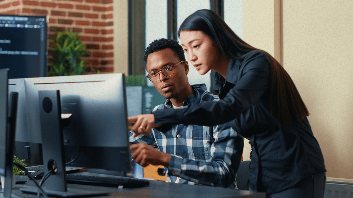 Two people looking at a computer.